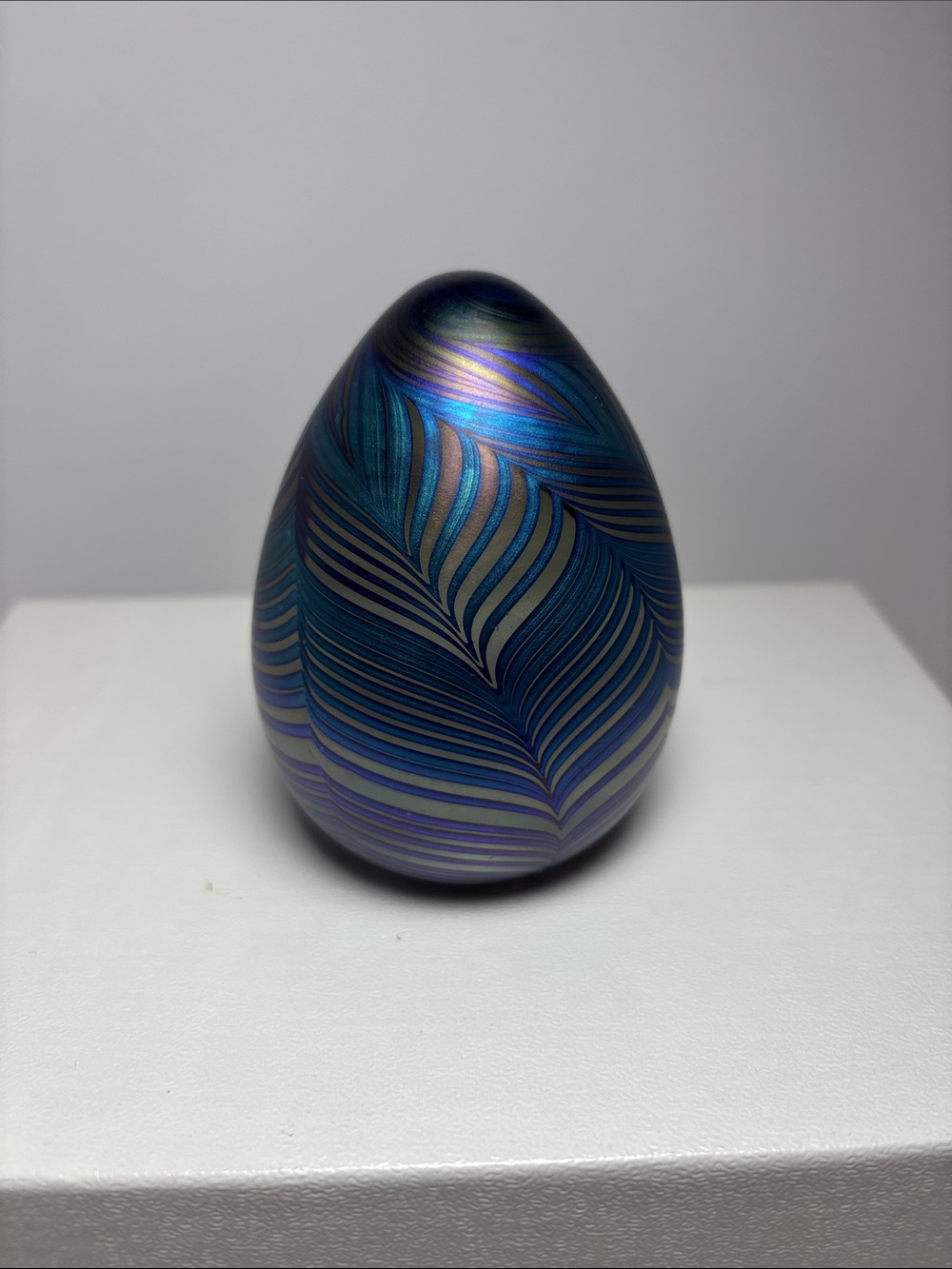 Blown glass Blue Iridescent Feather-Pattern egg shaped paper weight.